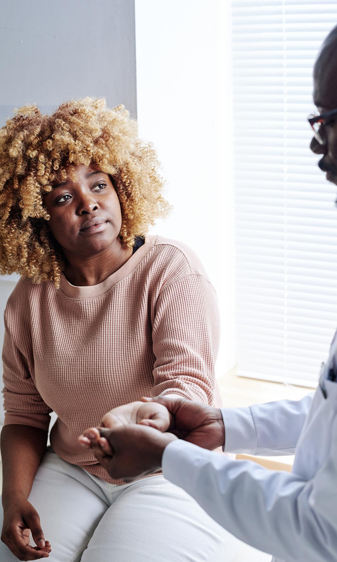 Doctor holding patient's wrist